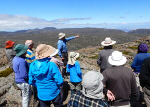 Ben Lomond - Mike Douglas points out features of the view across the southern end of the plateau and beyond. (RC)